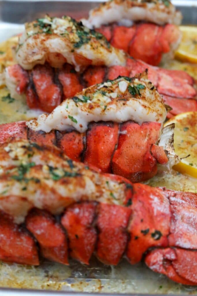 Cooked lobster tails on a sheet pan