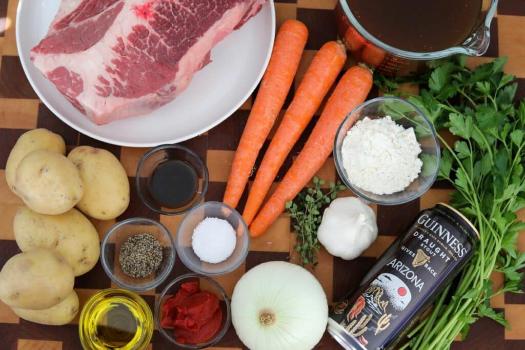 Ingredients for Irish beef stew on a wooden cutting board