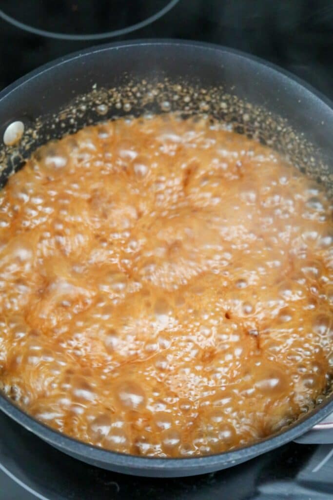 Cream added to caramel with violent bubbles
