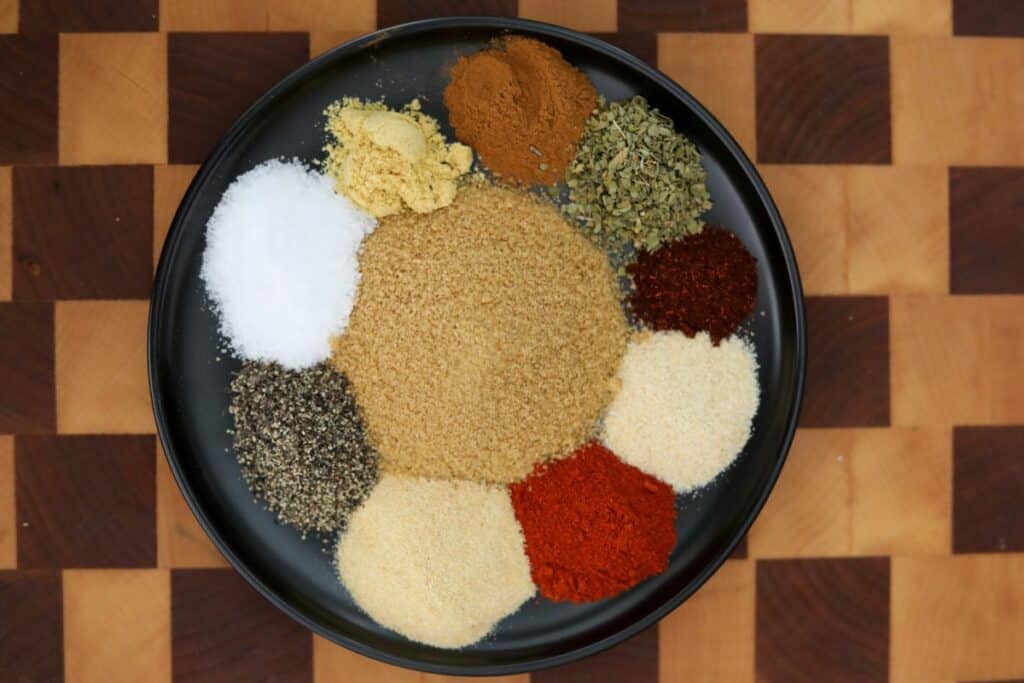 Ingredients for barbecue rib rub on a wooden cutting board
