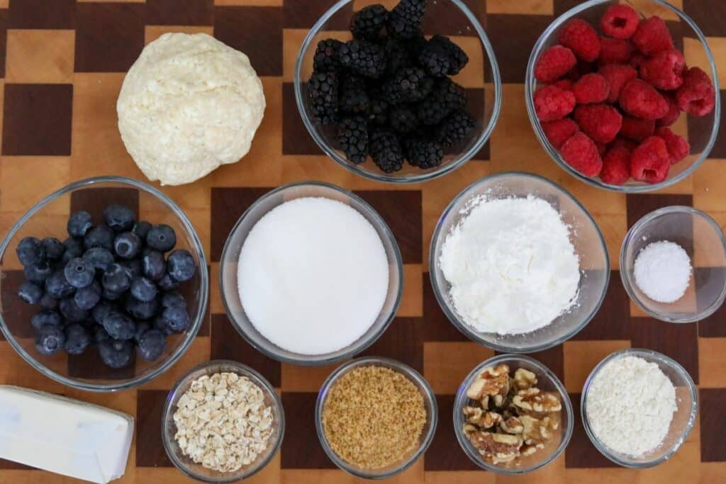 Ingredients for a berry tart on a wooden cutting board