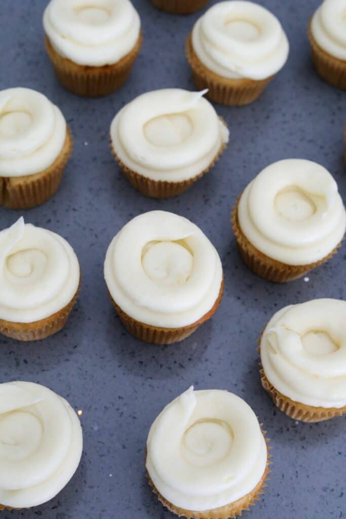 Well of cream cheese frosting on cupcakes