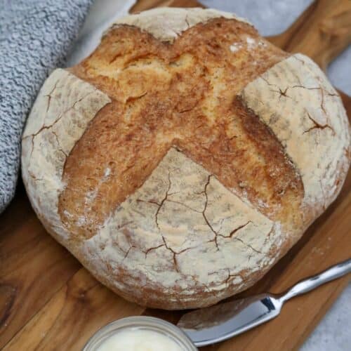 A crusty French bread loaf on a cutting board