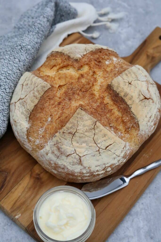 A crusty French bread loaf on a cutting board