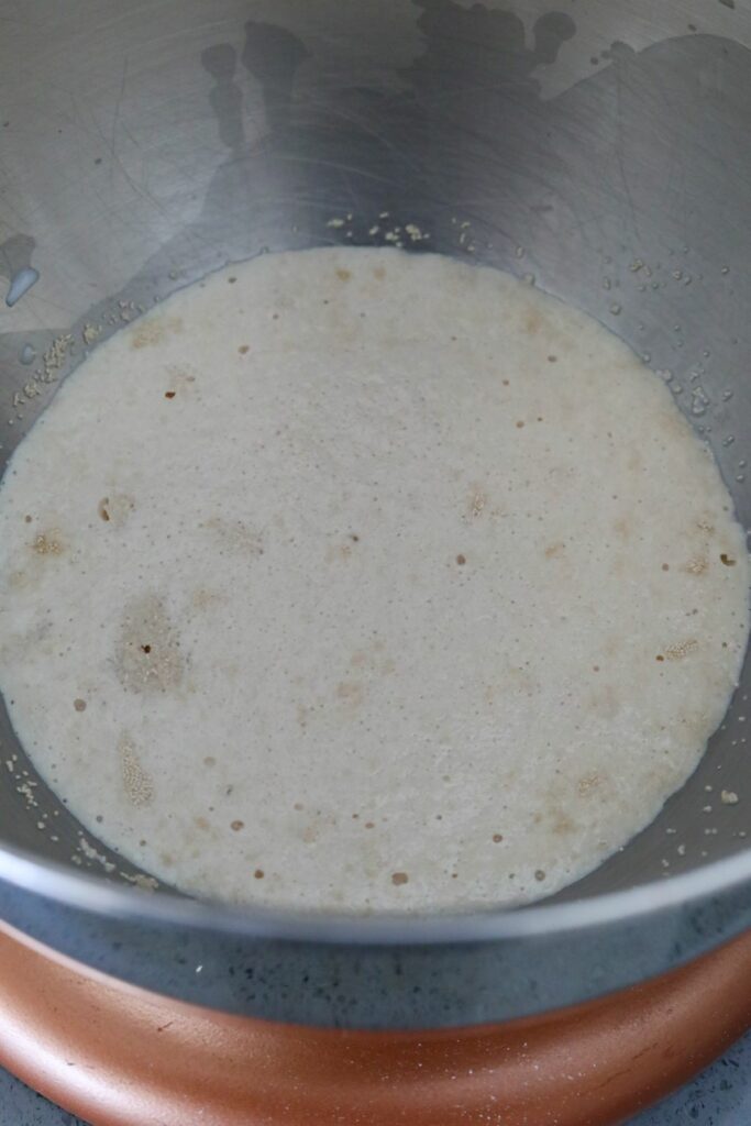 Proofed yeast in a metal bowl