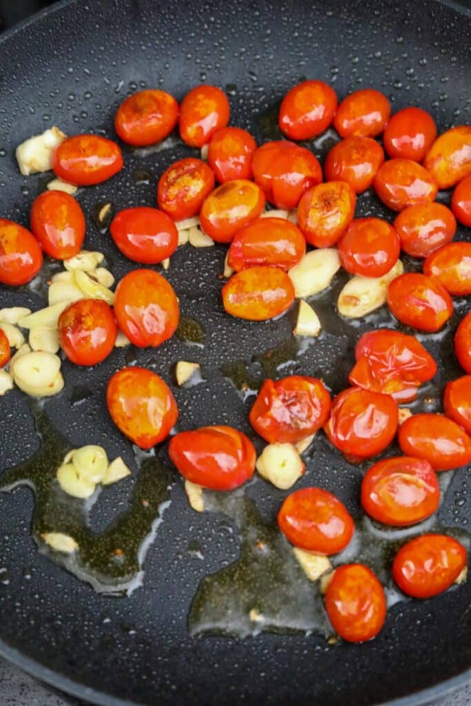 Blistered tomatoes and garlic in a pan