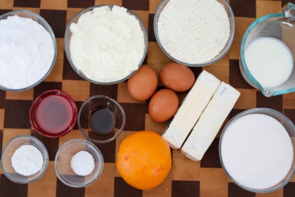 Ingredients for ricotta cake on a wooden cutting board