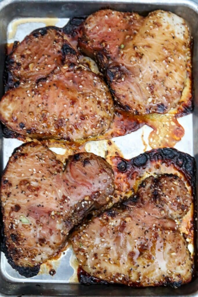 Cooked pork chops on a sheet pan