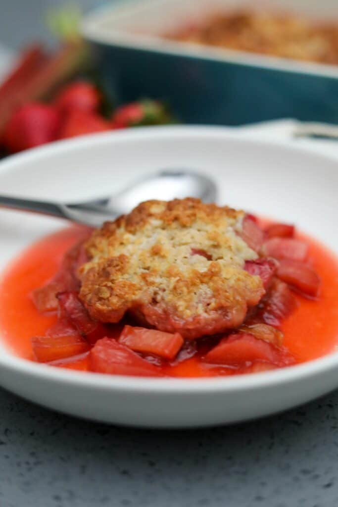 A serving of rhubarb cobbler in a white bowl