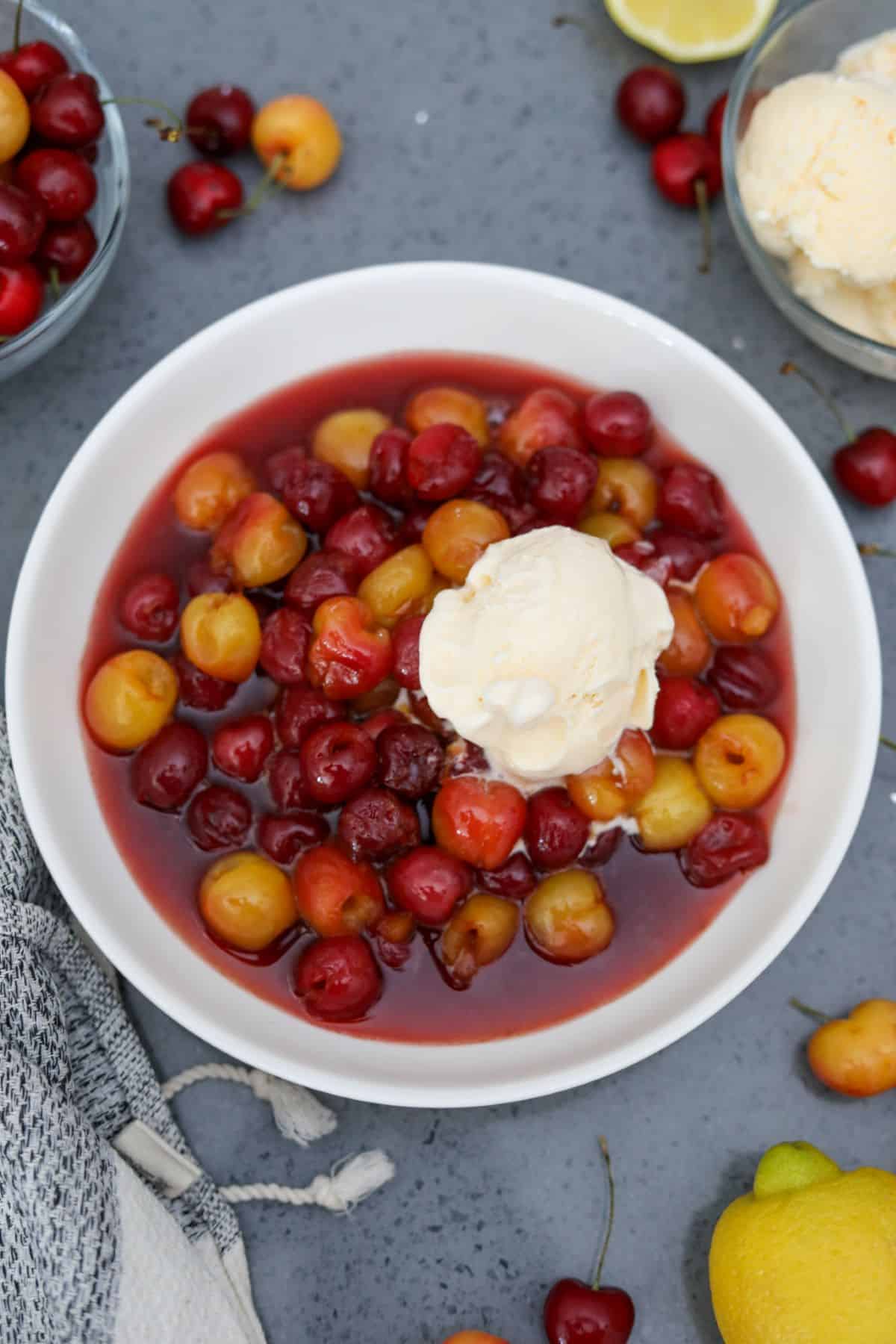 A white bowl of cherries jubilee