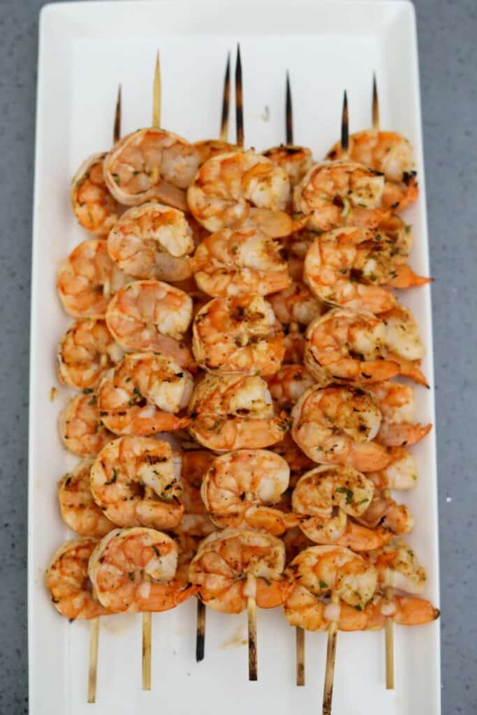 Cooked shrimp skewers on a platter