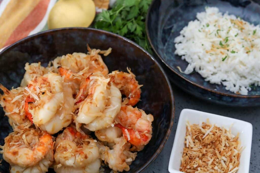 Coconut and rum shrimp in a bowl with rice in another bowl