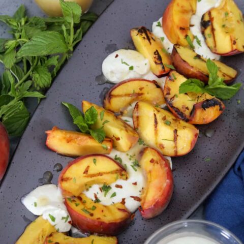 grilled peach salad on a serving dish