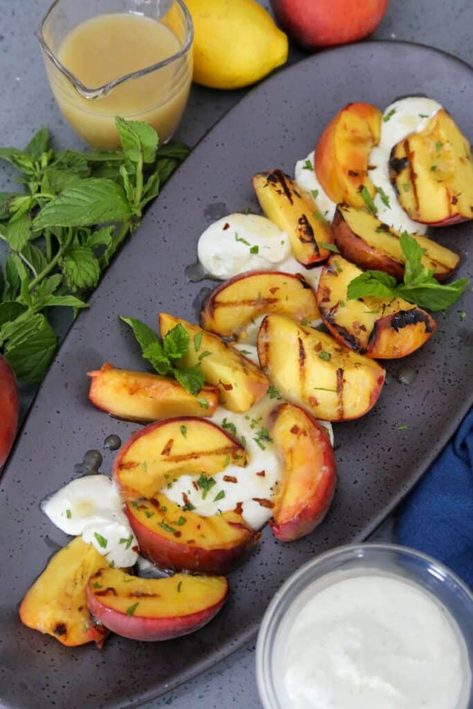 grilled peach salad on a serving dish