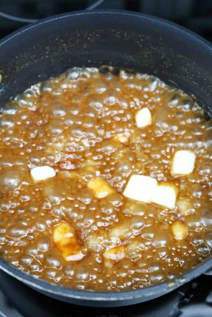 Butter added to the caramel sauce in a saucepan
