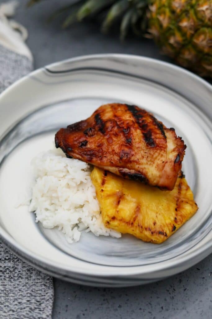 A serving of pineapple chicken on a plate with rice.