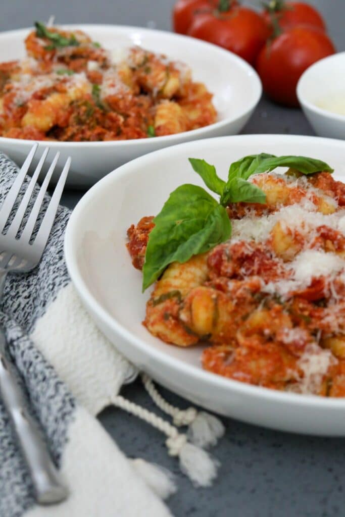 Two bowls of cooked gnocchi