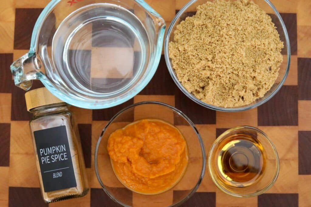 Ingredients for pumpkin spice syrup on a wooden cutting board