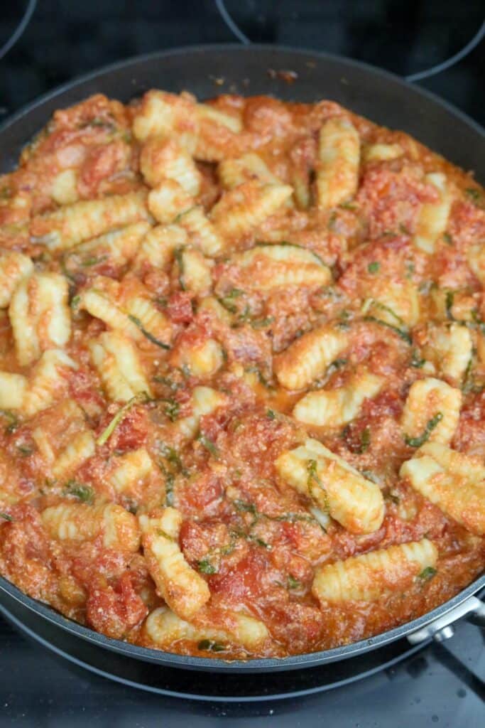Tomato and basil gnocchi in a pan