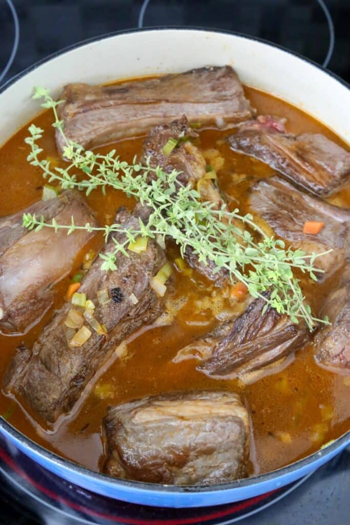 Broth and thyme added to short ribs