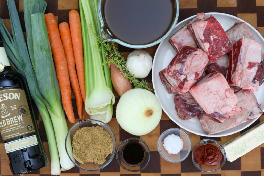 Ingredients for Irish whiskey short ribs on a wooden cutting board