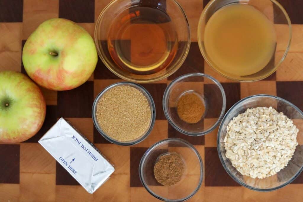 Ingredients for bourbon hasselback apples on a wooden cutting board