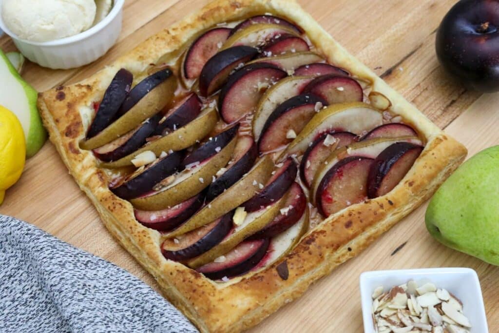 Serving a pear and plum tart