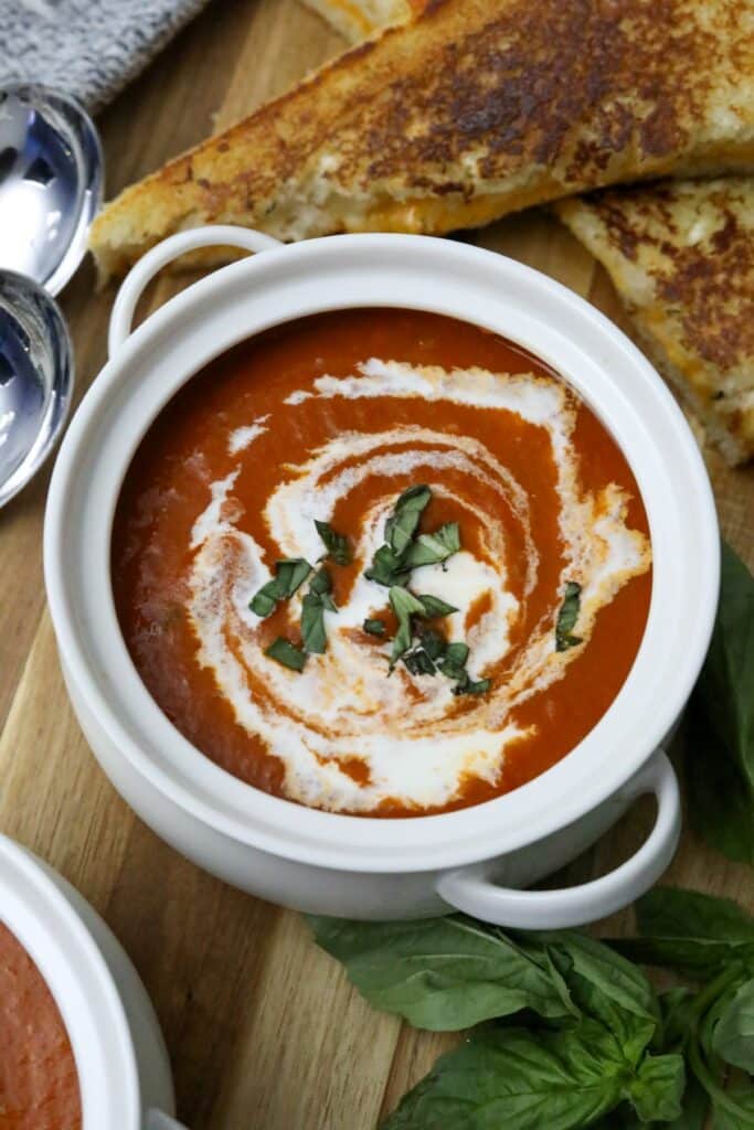 A white bowl with roasted tomato soup