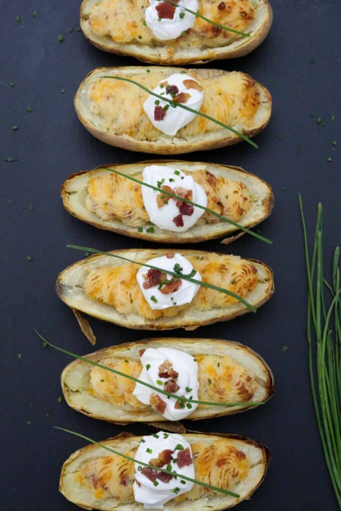 6 twice baked potatoes on a slate plate