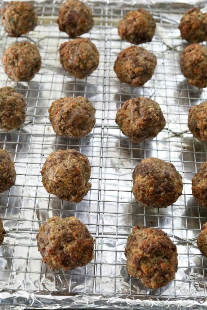 Cooked meatballs on a cooking rack