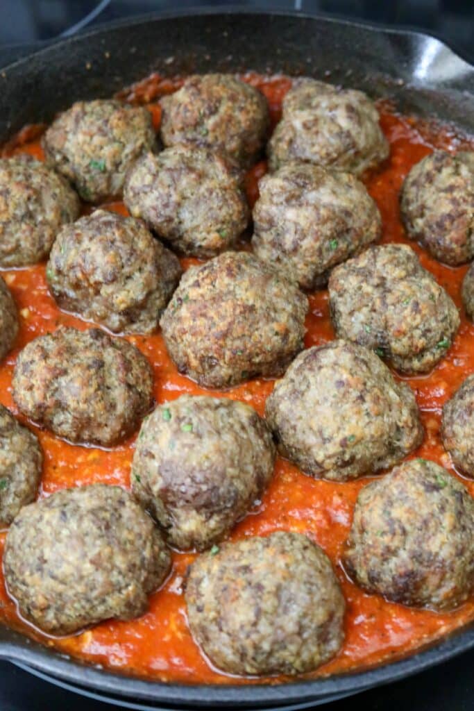 Meatballs added to skillet with tomato sauce