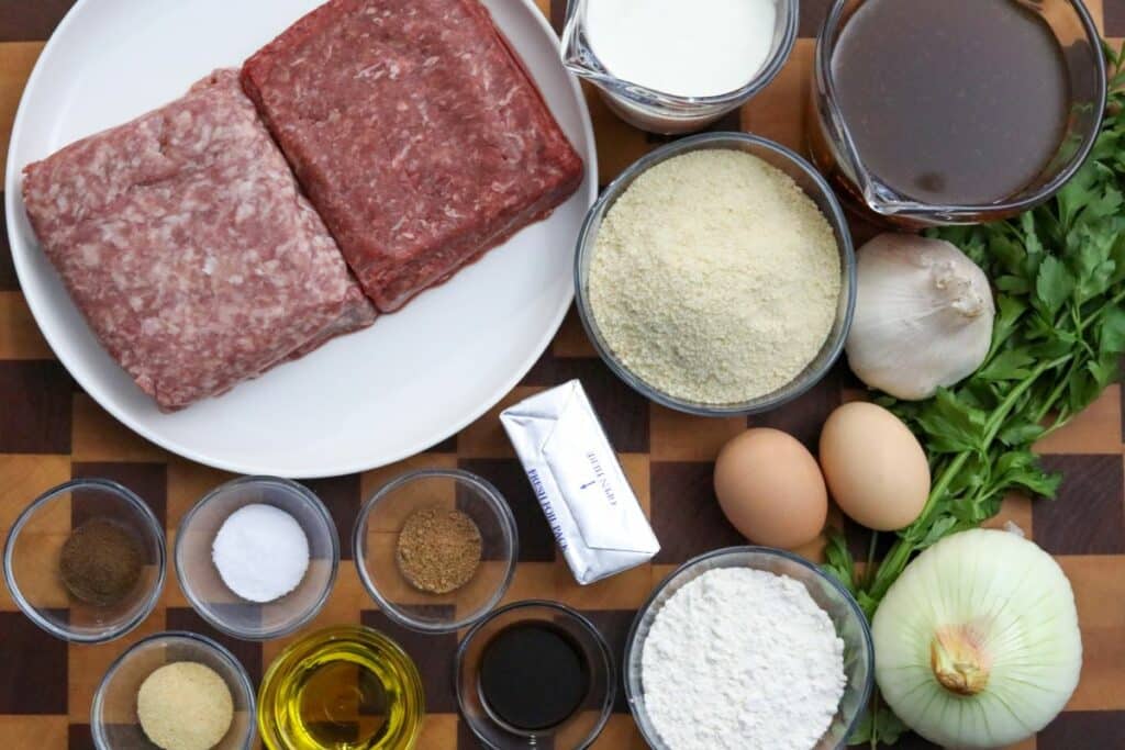 Ingredients for Swedish meatballs on a wooden cutting board