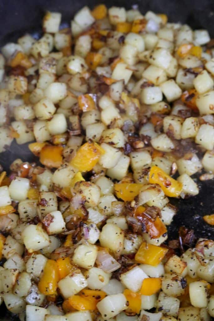 Cooking bacon potato hash in a skillet