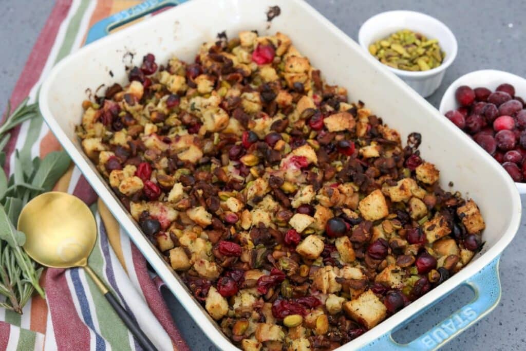 Long shot of cranberry and pistachio dressing in a blue baking dish