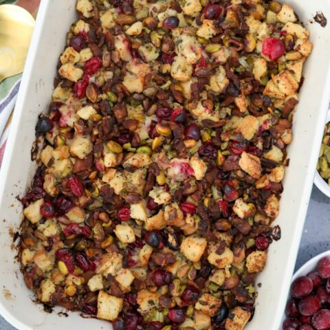 Cranberry and pistachio dressing in a blue baking dish ready to serve
