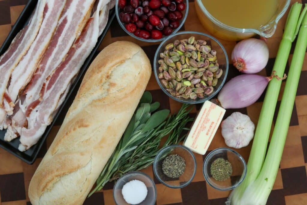 Ingredients for cranberry and pistachio dressing on a wooden cutting board