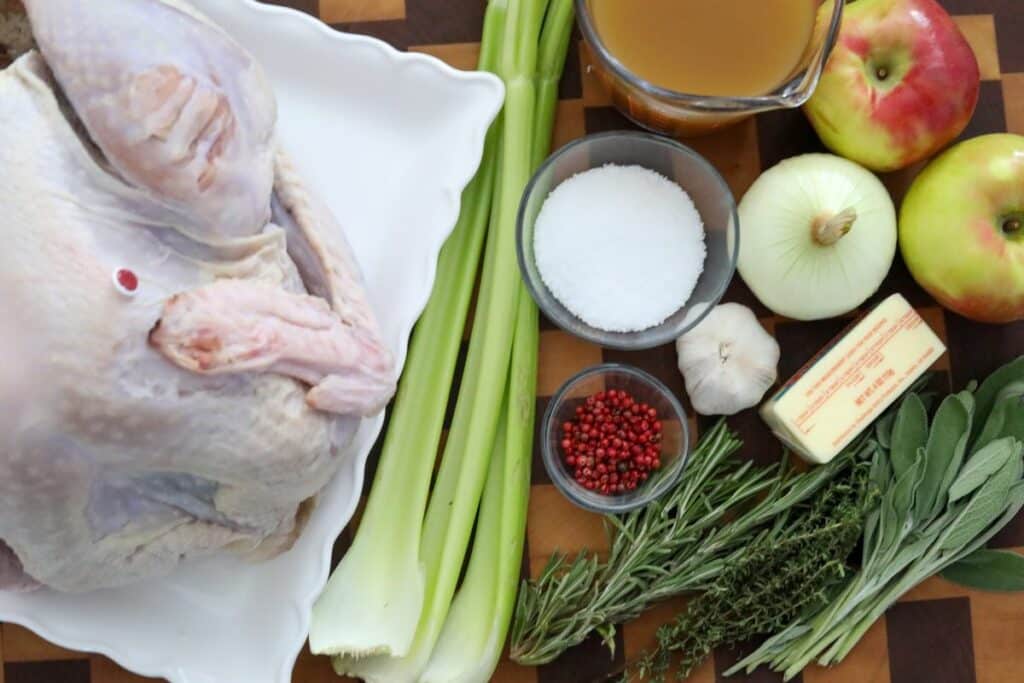 Ingredients for roast turkey on a wooden cutting board