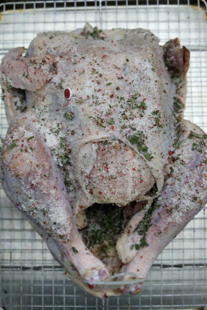 Turkey rubbed with dry brine on a baking rack