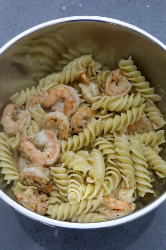 Shrimp and pasta in a mixing bowl