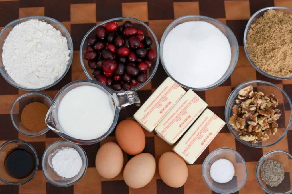 Ingredients for cranberry walnut upside down cake on a wooden cutting board