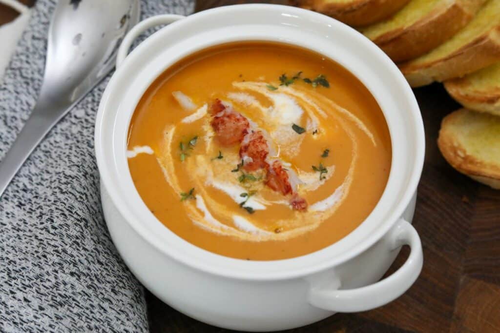 A bowl of lobster bisque with toast