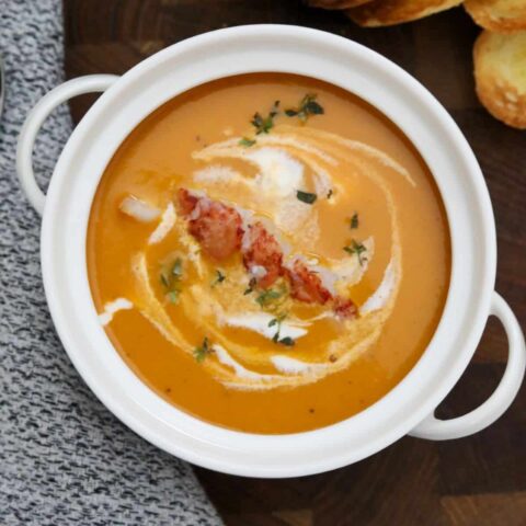 A white soup crock of lobster bisque