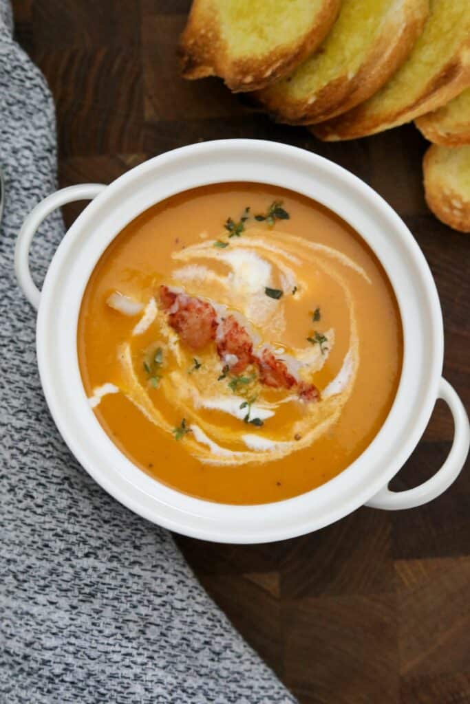 A white soup crock of lobster bisque
