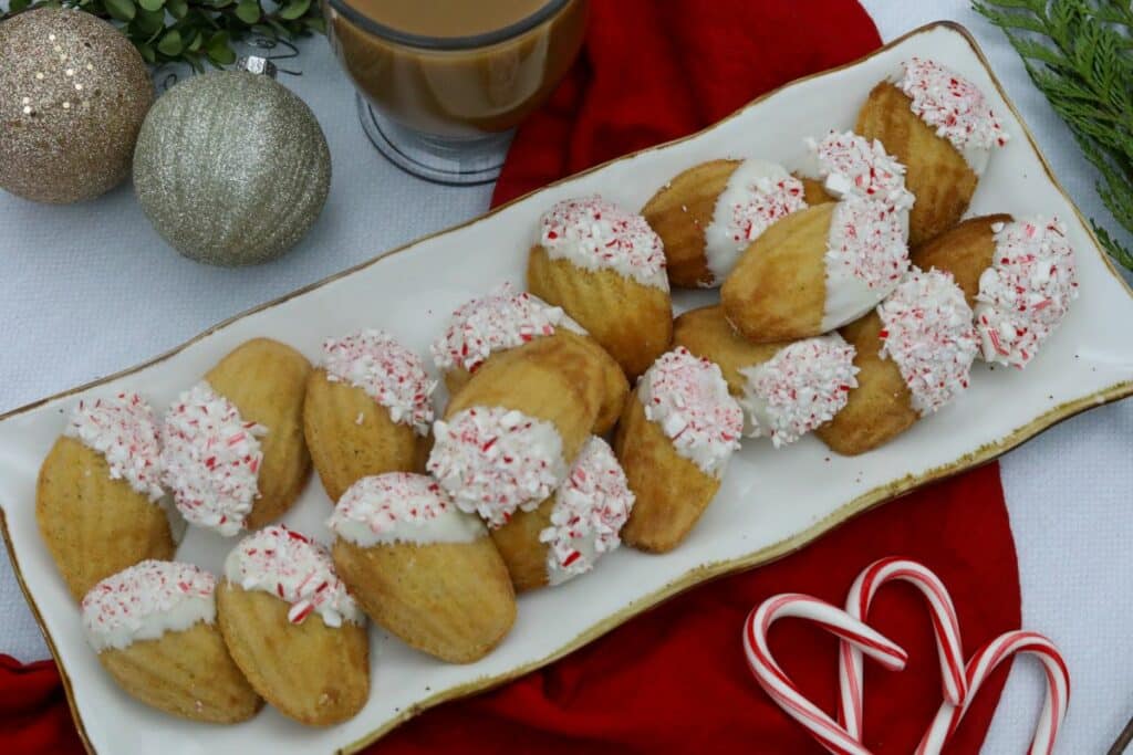 White chocolate peppermint madeleine on a platter with a cup of coffee