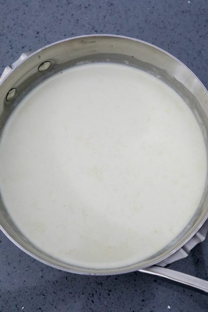 A saucepan with heated cream