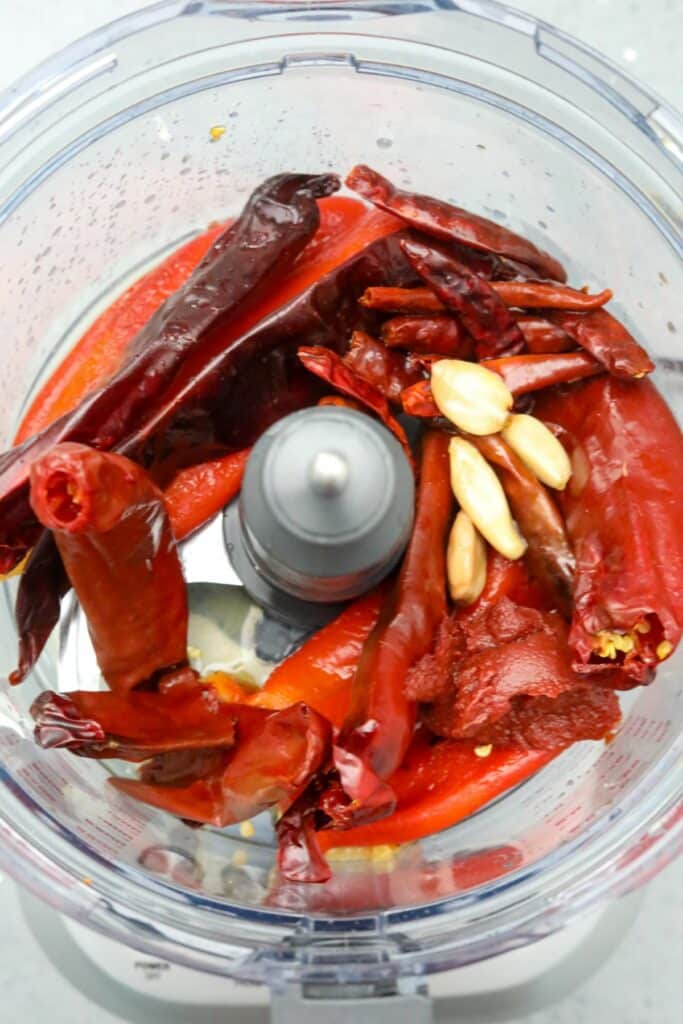 Ingredients for harissa in a food processor