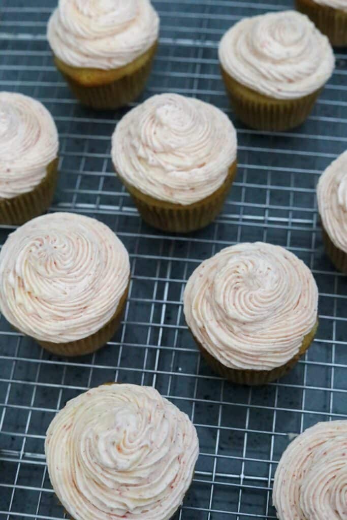 Iced cupcakes on a cooling rack