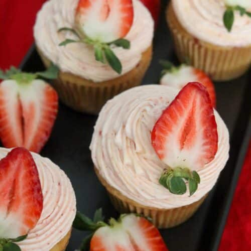 Close up of strawberry cupcakes on a black platter