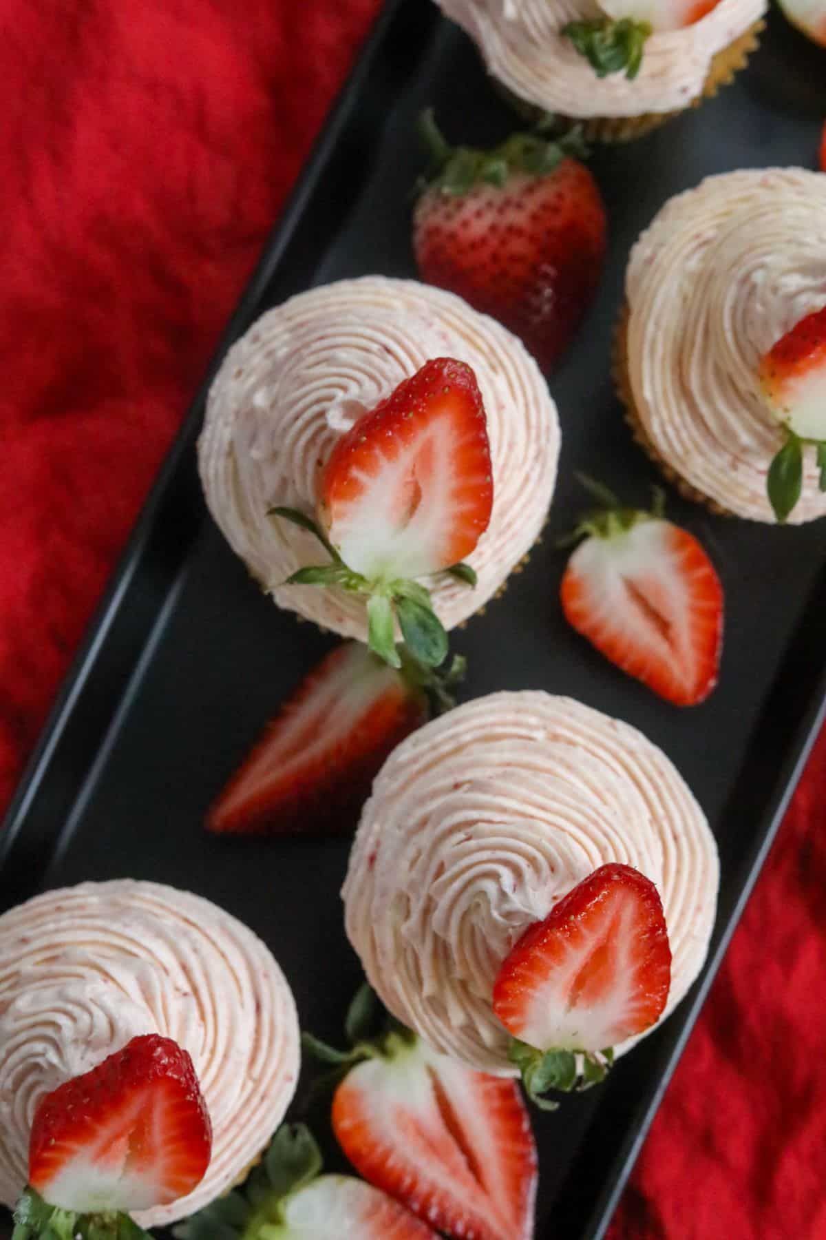 Strawberry cupcakes on a black platter