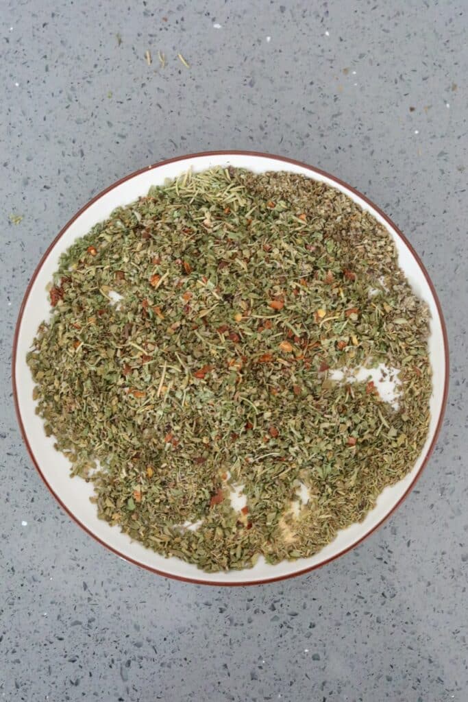 A mixture of Italian seasoning on a white plate